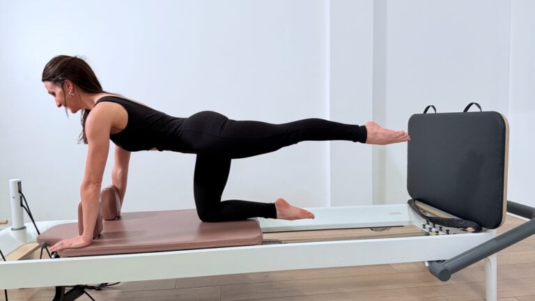Katie Sovenyhazy demonstrating a kneeling reformer exercise